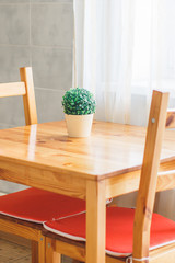 Details of a classic interior. Wooden dining area. Scandinavian style cuisine of the apartment in warm colors