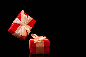 Gift box with white ribbon on black background. zero gravity. levitation. milimalism. Concept sales, shopping, christmas holidays, valentin's day and birthday.