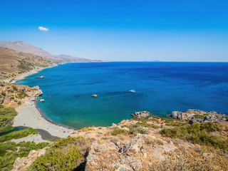 Panorama of Preveli beach (Palm beach) at Libyan sea, with river and palm forest, Crete, Greece. Preveli beach and lagoon is located below the monastery in from of an extensive glade of palm trees
