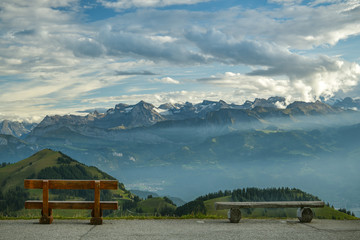 Fototapeta premium Two benches with beautiful view on Swiss Alps on top of Mount Rigi