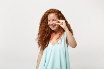 Fototapeta premium Young smiling redhead woman in casual light clothes posing isolated on white wall background studio portrait. People lifestyle concept. Mock up copy space. Gesturing demonstrating size with workspace.