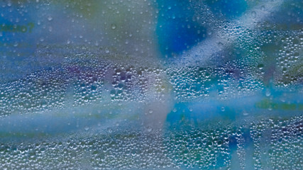 Obraz premium water drops on a blue abstract background.