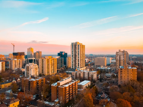 Aerial photo of the cityscape and downtown skyline in London, Ontario, Canada as the sun sets in late Autumn, November 2019.