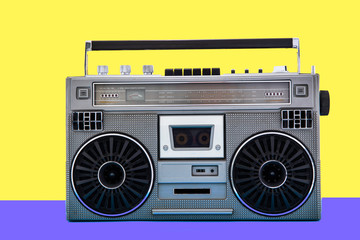 1980s Silver retro radio boom box on color background. Disco music