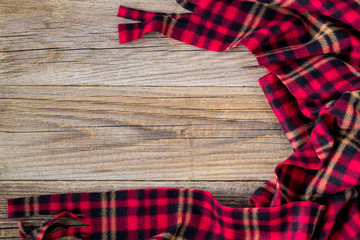 background of red plaid and wooden boards. Top view with copyspace