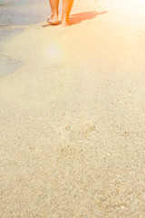beautiful legs on the sand by the sea