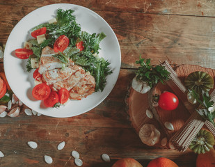 Grilled chicken breast. Grilled chicken fillet and salad of fresh vegetables from tomatoes, cucumbers and arugula leaves. Chicken meat salad. Healthy food. The apartment was lying. View from above.
