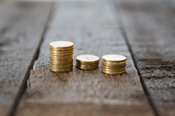 Gold money coins pile on wooden table
