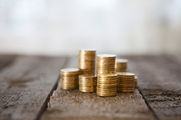 Gold money coins pile on wooden table