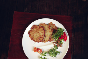 Grilled chicken breast. Grilled chicken fillet and salad of fresh vegetables from tomatoes, cucumbers and arugula leaves. Chicken meat salad. Healthy food. The apartment was lying. View from above.