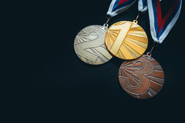 Gold, silver and Bronze medal, sport trophy photo, black background. Summer game, Tokyo 2020