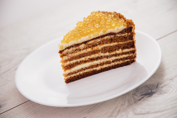 Fototapeta na wymiar Honey cake with golden pearls isolated on white background