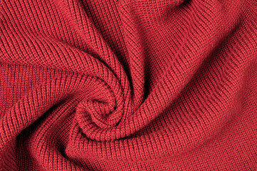 Red background from red knitted wool closeup 