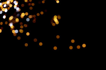 big yellow golden bokeh for background on black. Christmas lights.