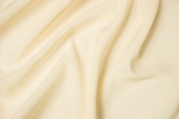 Fototapeta na wymiar Abstract folds. Delicate silk drapery. Beige color.