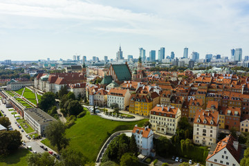Fototapeta na wymiar Aerial view of the old city and the royal palace in the historical center of Warsaw, Poland. Drone shot flying over city buildings in the Old Town.