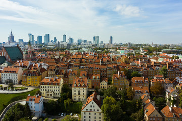 Fototapeta na wymiar Aerial view of old buildings, castles and a church in the old city of Warsaw. Poland. Flight of the drone over the old city on a sunny summer day.