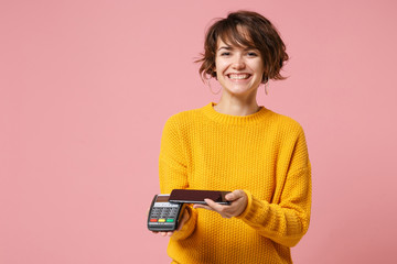Smiling young woman in yellow sweater posing isolated on pink background. People lifestyle concept....