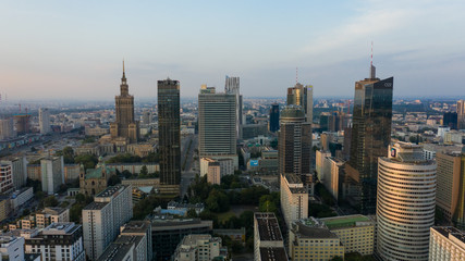 Fototapeta premium Warsaw Poland. 16. July. 2019. Aerial view of modern skyscrapers and buildings at sunrise. City in the foggy mist.