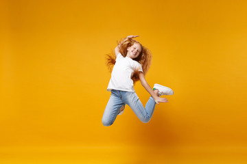 Cheerful little ginger kid girl 12-13 years old in white t-shirt isolated on yellow background...