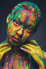 Möbelaufkleber Junge Frau mit bunter Farbe bedeckt © Nejron Photo