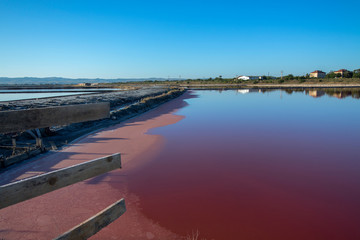 Landscape in pink and blue. Salt mines and the path between them. With reflection.  Burgas, Bulgaria.