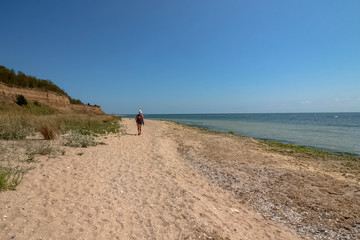 Traveler on a deserted beach. Northern Black Sea, the last sandy strip before the Romanian border. Durankulak, Bulgaria