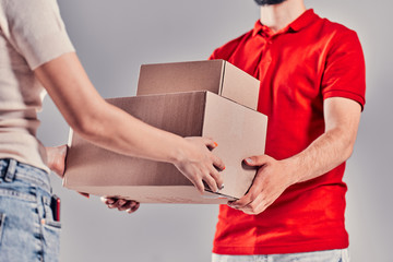 Man on gray background. Courier, Delivery Man.