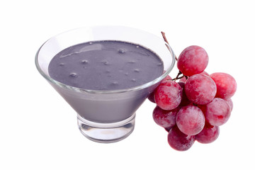 Black yogurt in a bowl with red grapes