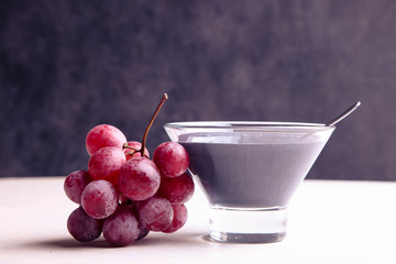 Black yogurt with red grapes