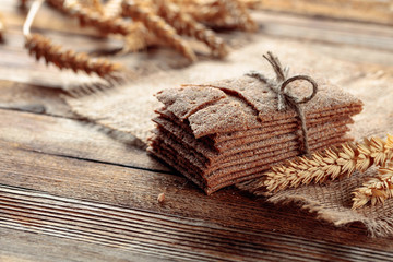 Rye crackers and ears on a old wooden table.