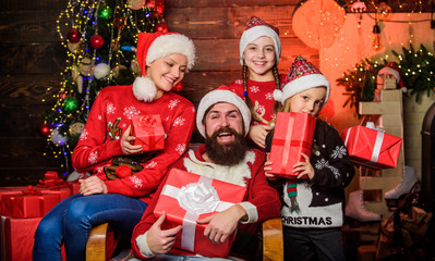 The best place. cheerful mother love children. santa father at decorated tree. small girls sisters with parents. open xmas present. gifts from santa. Happy family celebrate new year and Christmas