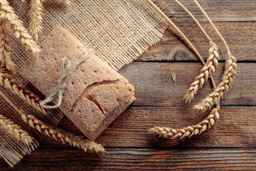 Rye crackers and ears on a old wooden table.