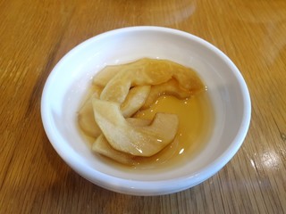 Korean food style, Top view of Stewed potatoes in white  plate on wooden table in restaurant, copy space, Ready to eat