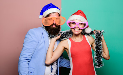 Corporate holiday party ideas. Christmas party office. Winter corporate party. Office christmas party. Happy man and woman wear santa hats and funny sunglasses. Cheerful couple celebrate new year