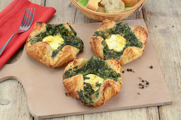 puff pastry with goat cheese and spinach on a chopping board