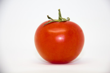 red homemade tomato on a white background