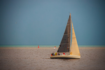Sailing Regatta in the wind through the waves at the sea