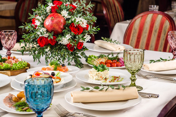Beautiful restaurant interior table decoration for wedding or event. Flower Wedding Table Decoration, Autumn colors. European food in a restaurant setting. Table set for party.