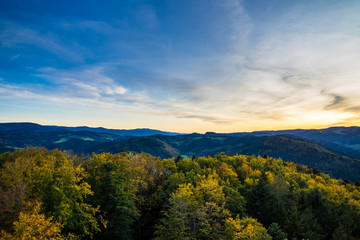 Germany, Endless wide beautiful black forest holiday nature landscape above tree tops at sunset in autumn season