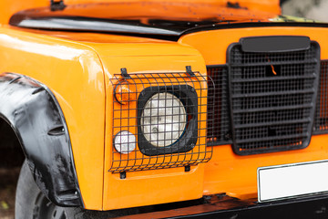 Vintage orange color 4x4 off-road car, the car is old and has been modified.