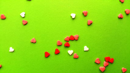 Valentine's Day. Frame made of gifts, candles, confetti on green background. Valentines day background. Flat lay, top view, copy space.	