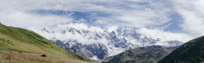 Fototapeta na wymiar Panoramic view of Peak Shkhara Zemo Svaneti, Georgia. The main Caucasian ridge
