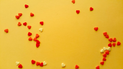 Valentine's Day. Frame made of gifts, candles, confetti on yellow background. Valentines day background. Flat lay, top view, copy space.