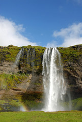 Seljalandsfoss Waterfall in Iceland. A famous waterfall with a path to walk behind the falls.