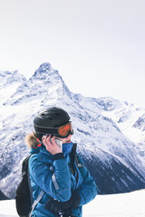 Fototapeta na wymiar Girl snowboarder using smartphone.