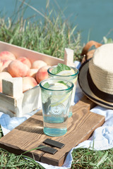 Picnic with peach lemonade in sunny weather