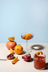 Summer cocktails with fresh pomegranate, grapefruit, orange and lemon slices. Abstract studio conception.