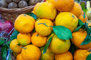 mandarins with leaves and another fruits in market