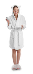 Young woman in bathrobe with cup of beverage on white background
